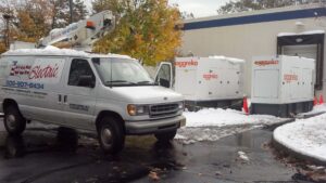 Icon Electric service van parked beside two large Aggreko generators in a snowy parking lot during an emergency power setup, with caution cones and snow-covered equipment visible.